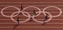 Oscar Pistorius (C) of South Africa runs with Luguelin Santos (R) of the Dominican Republic, Rusheen McDonald (L) of Jamaica and Maksim Dyldin of Russia during round 1 of the men's 400m heat 1 at the London 2012 Olympic Games at the Olympic Stadium August 4, 2012. Santos finished first with Pistorius coming second and Dyldin placing third. McDonald came in fourth. REUTERS/Pawel Kopczynski (BRITAIN - Tags: OLYMPICS SPORT ATHLETICS TPX IMAGES OF THE DAY) - RTR3632H