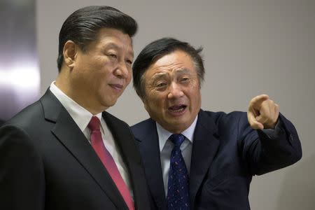 FILE PHOTO: Chinese President Xi Jinping (L) pauses as he is shown around the offices of Huawei Technologies Co Ltd by Ren Zhengfei, president of Huawei, in London, Britain, October 21, 2015. REUTERS/Matthew Lloyd/Pool/File Photo