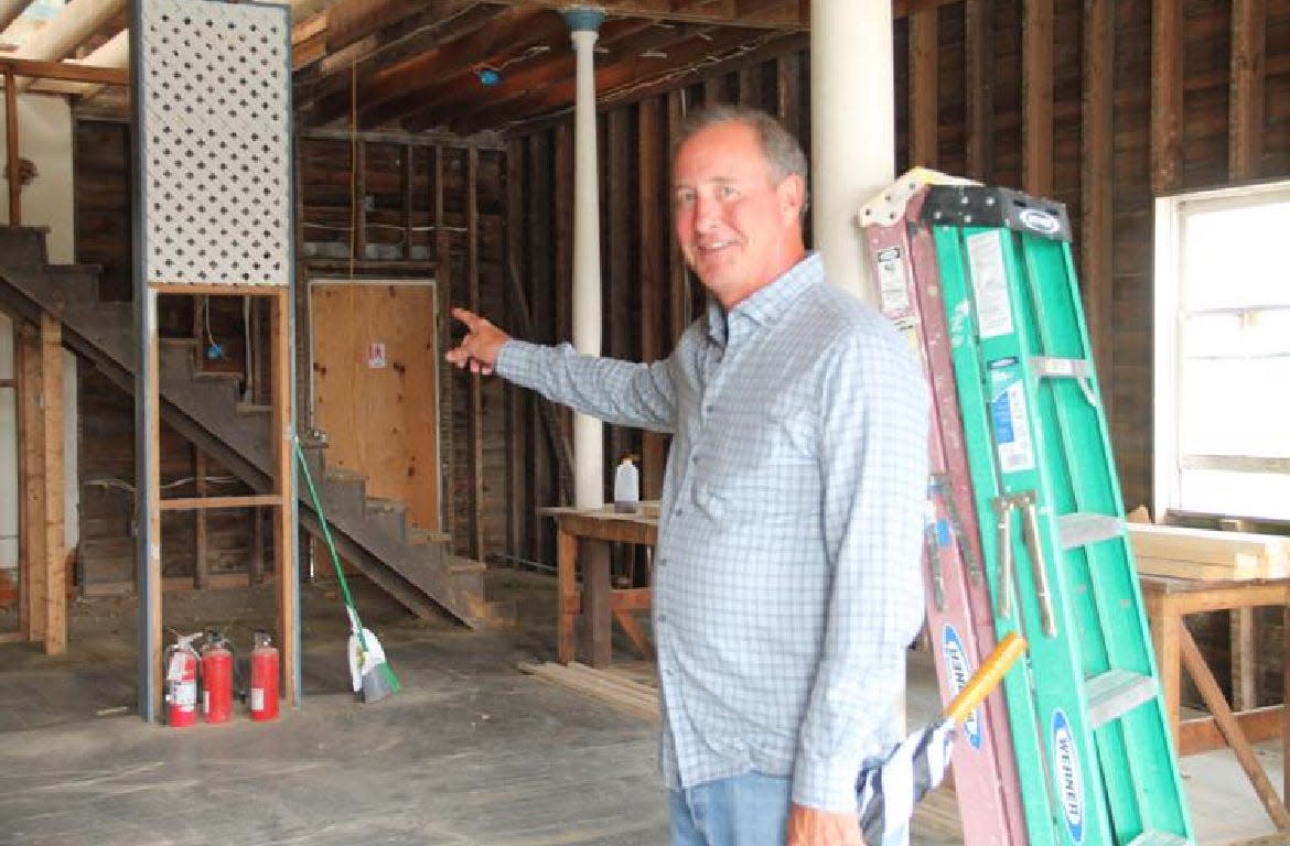 Real estate developer Brad Kline of Bradford Kline & Associates, pictured in October 2021, points to a storefront space inside a historic building in Ashburn, Virginia, where he planned to put a home decor store.