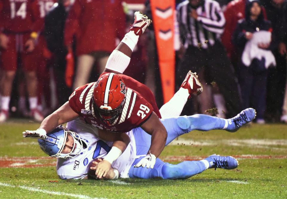 North Carolina State defensive tackled Alim McNeill sacks North Carolina quarterback Sam Howell on Nov. 30, 2019 in Raleigh, N.C.