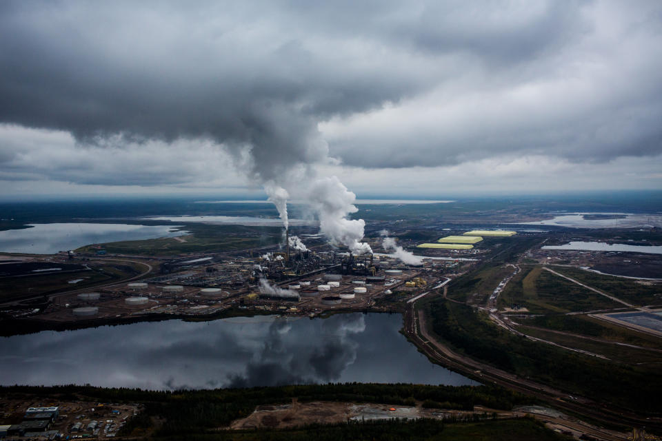 Steam rises from the Syncrude Canada Ltd. upgrader plant in this aerial photograph taken above the Athabasca oil sands near Fort McMurray, Alberta, Canada, on Monday, Sept. 10, 2018. Photographer: Ben Nelms/Bloomberg via Getty Images