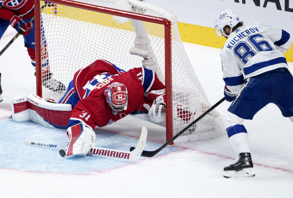 Montreal Canadiens goaltender Carey Price, left, makes a save off Tampa Bay Lightning's Nikita Kucherov during the second period of Game 3 of the NHL hockey Stanley Cup Final, Friday, July 2, 2021, in Montreal. (Paul Chiasson/The Canadian Press via AP)