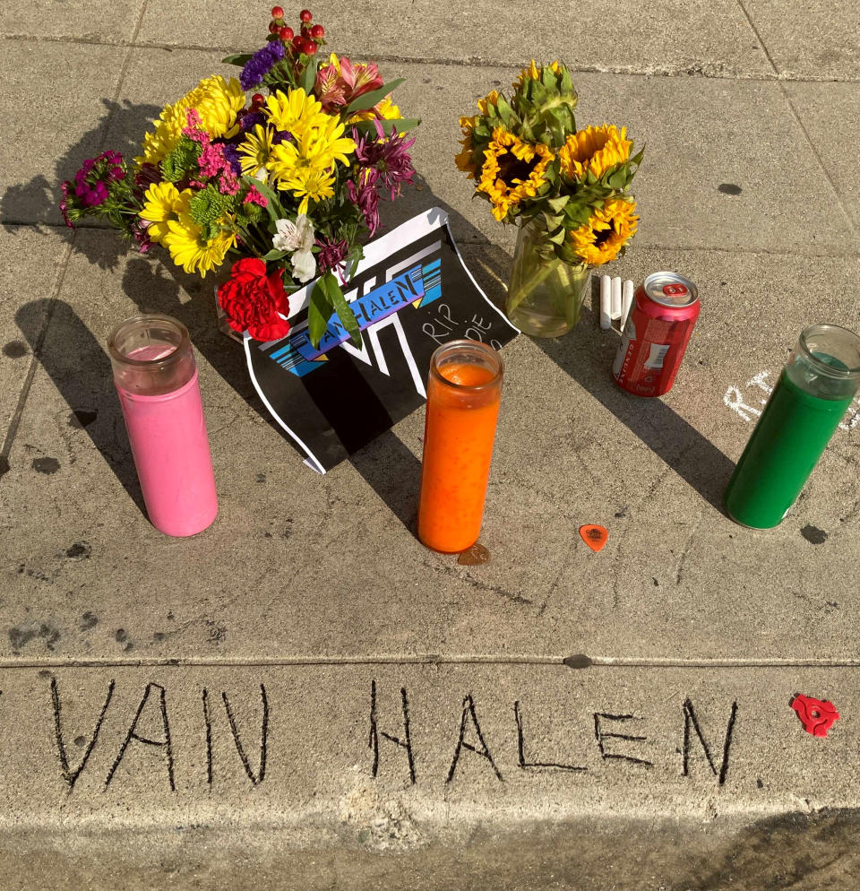 Legend has it that the name Van Halen, seen etched in concrete at the corner of Allen and Villa in Pasadena, Calif., was done by brothers Eddie and Alex Van Halen when they lived in Pasadena, Calif., in their younger years, where a sidewalk memorial has begun after Eddie's death from cancer at age 65, Tuesday, Oct. 6, 2020. Guitar virtuoso Eddie Van Halen is being mourned across the world of music. Artists from Lenny Kravitz to Kenny Chesney are honoring Van Halen, whose blinding speed, control and innovation propelled his band into one of hard rock's biggest groups. (AP Photo/Andrew Dalton)