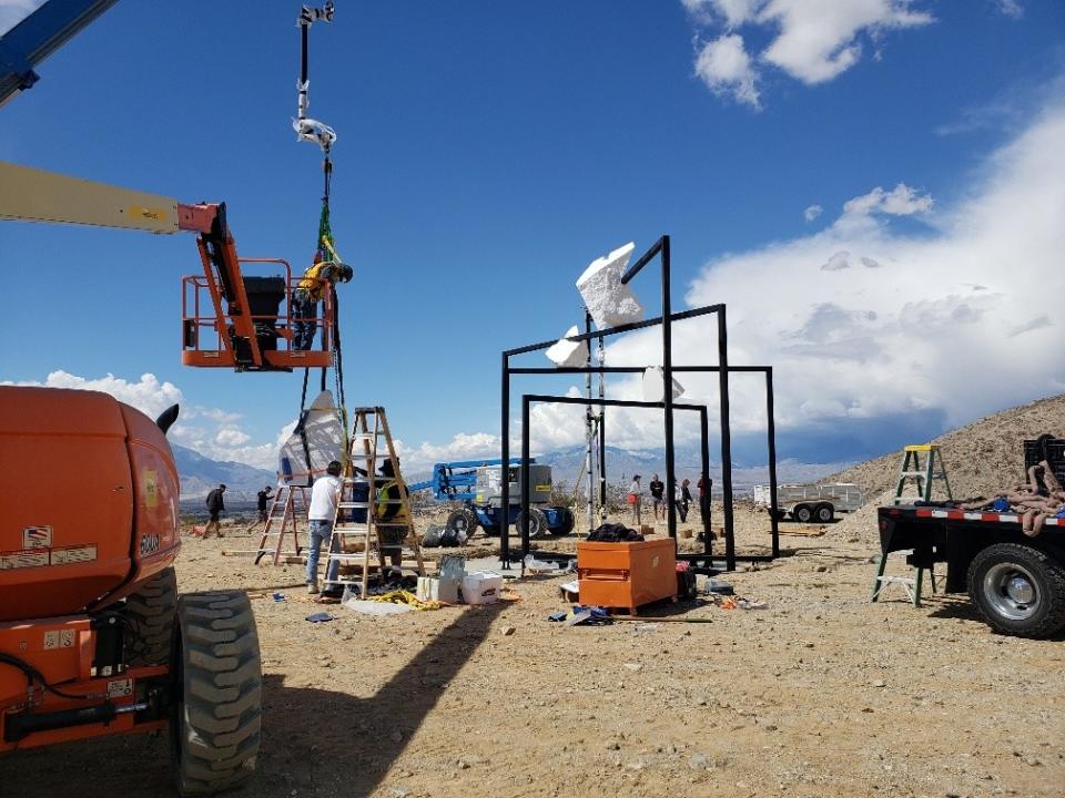 A construction crew works to assemble Alicja Kwade's work for DesertX.