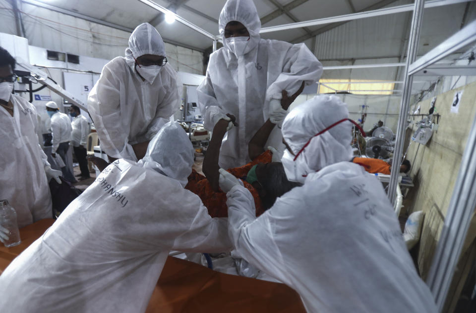 Health workers attend to a patient at the BKC jumbo field hospital, one of the largest COVID-19 facilities in Mumbai, India, Thursday, May 6, 2021.(AP Photo/Rafiq Maqbool)