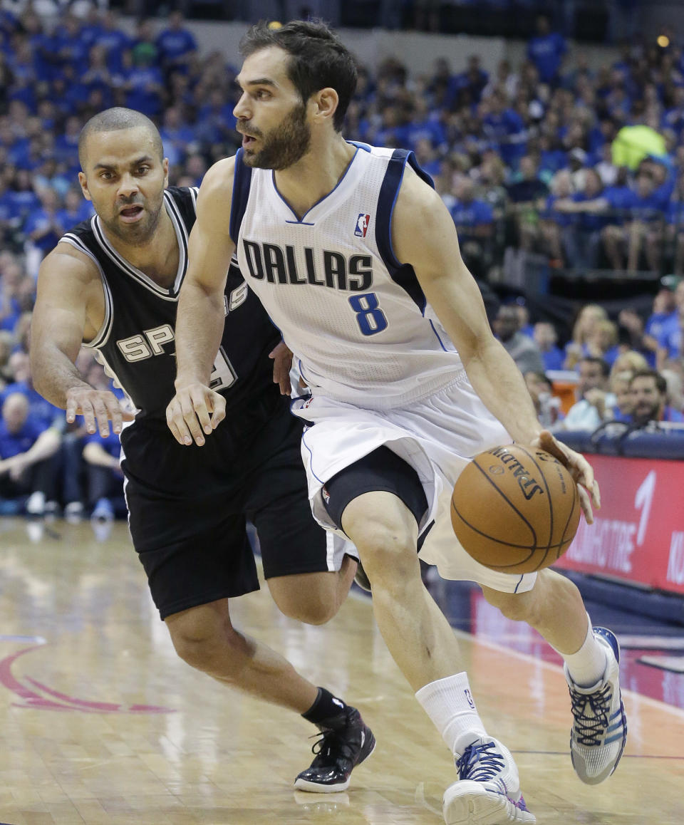 Dallas Mavericks guard Jose Calderon (8) of Spain, drives against San Antonio Spurs guard Tony Parker (9) of France, during the first half in Game 3 in the first round of the NBA basketball playoffs in Dallas, Saturday, April 26, 2014. (AP Photo/LM Otero)