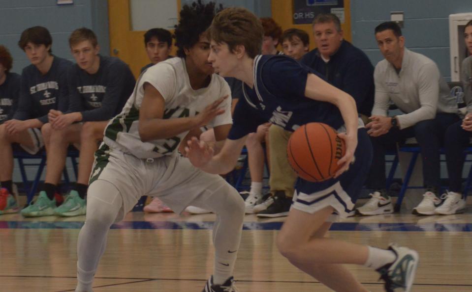 St. Thomas Aquinas freshman Cole McClure drives for two of his 20 points in Thursday's championship game of the Oyster River Holiday Classic.