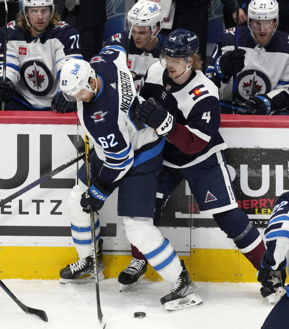 Winnipeg Jets right wing Nino Niederreiter, left, and Colorado Avalanche defenseman Bowen Byram vie for the puck duirng the first period of an NHL hockey game Thursday, April 13, 2023, in Denver. (AP Photo/David Zalubowski