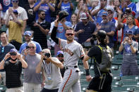 San Francisco Giants' Kris Bryant greets Chicago Cubs fans as he walks to the dugout before a baseball game in Chicago, Friday, Sept. 10, 2021. (AP Photo/Nam Y. Huh)
