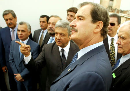 FILE PHOTO: Mexico City mayor Andres Manuel Lopez Obrador (C) points as Mexican President Vicente Fox (R) listens during a tour of a project to rejuvenate the capital's city center May 29, 2003. REUTERS/Daniel Aguilar/File Photo