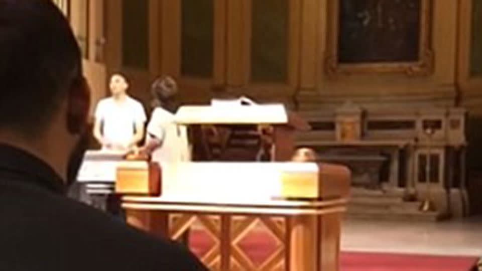 The man can be seen ranting in front of the church organ. Source: YouTube