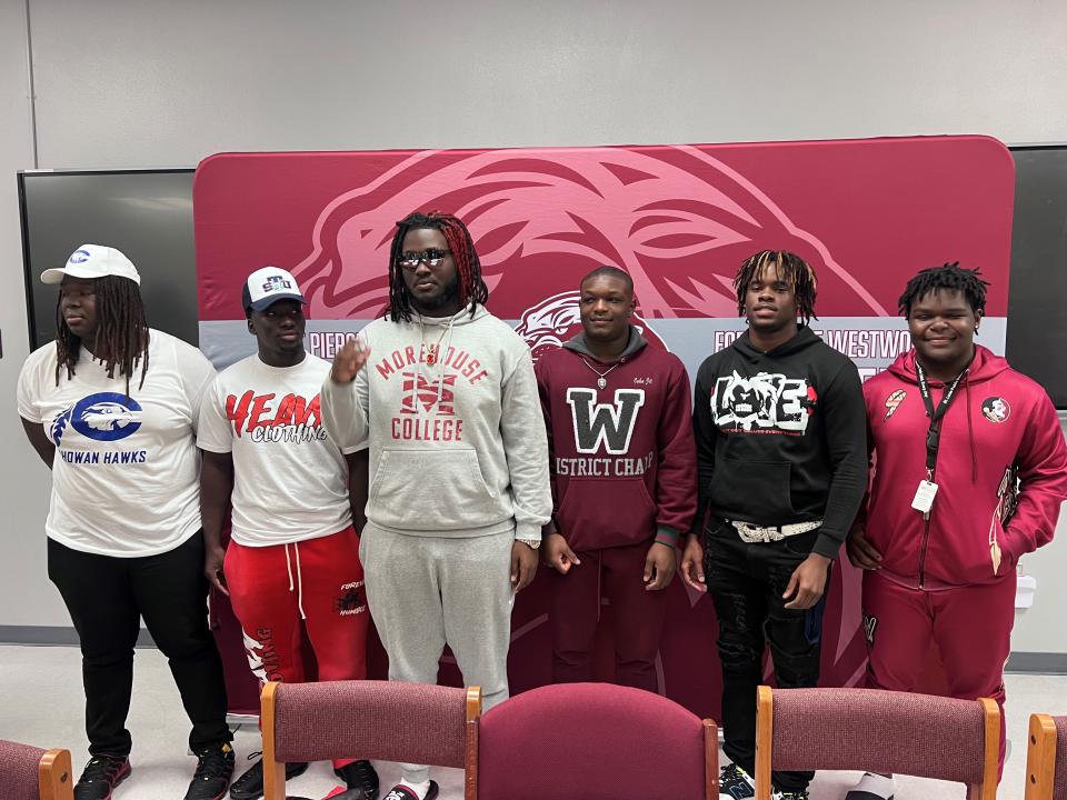 (From L to R) Westwood football players Chris Pierre, Todd Jackson, Dwayne Chaney, Rhashod Brown, John Williams and Chris Anderson pose for photos after signing their college letters of intent on Wednesday, Feb. 7, 2024 from Fort Pierce Westwood High School.