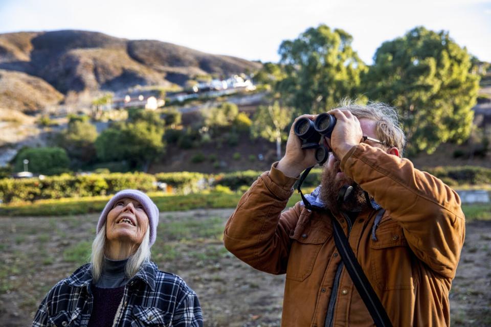 Another butterfly expert bundled up in a knit cap and cozy plaid jacket joins the search.