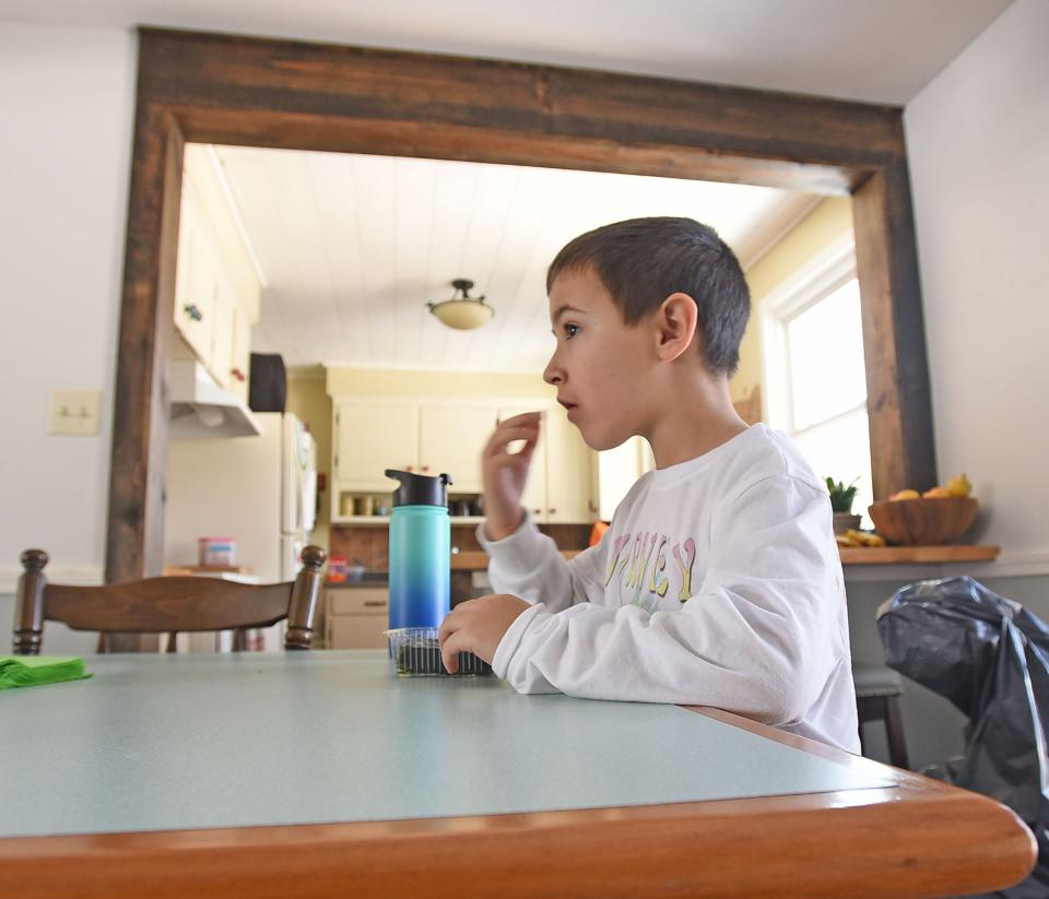 Max Quimby enjoys a snack in his home Wednesday morning.