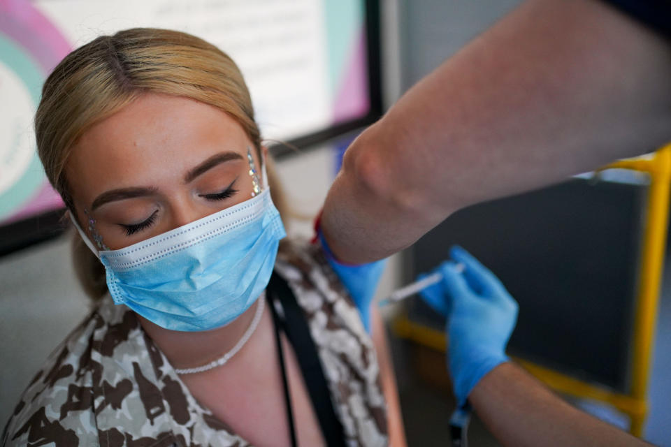 <p>Festival goer Ellie Harries receives her 2nd Pfizer vaccine dose at a Covid-19 vaccination bus at Latitude festival in Henham Park, Southwold, Suffolk. Picture date: Sunday July 25, 2021. (Photo by Jacob King/PA Images via Getty Images)</p>
