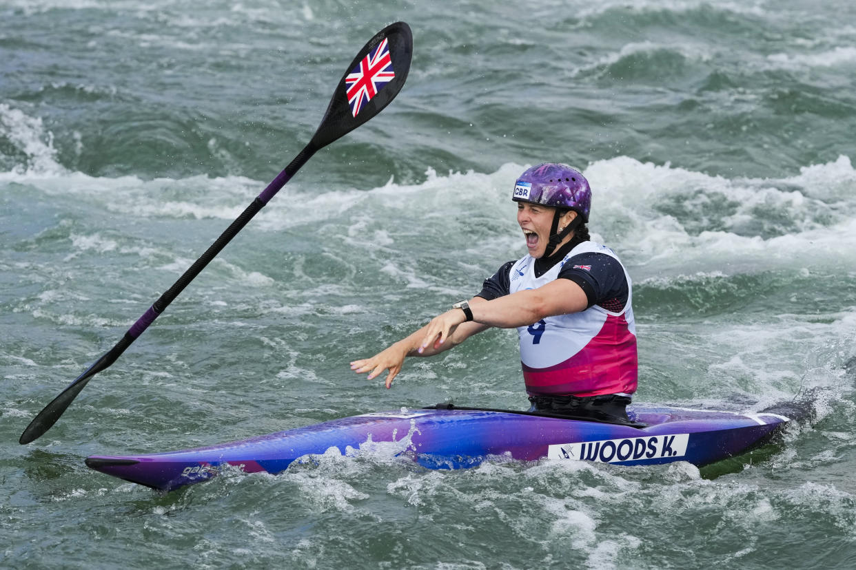 Kimberley Woods of Britain on the water reacts with her paddle after competing in women's kayak single finals during the canoe slalom in Vaires-sur-Marne.