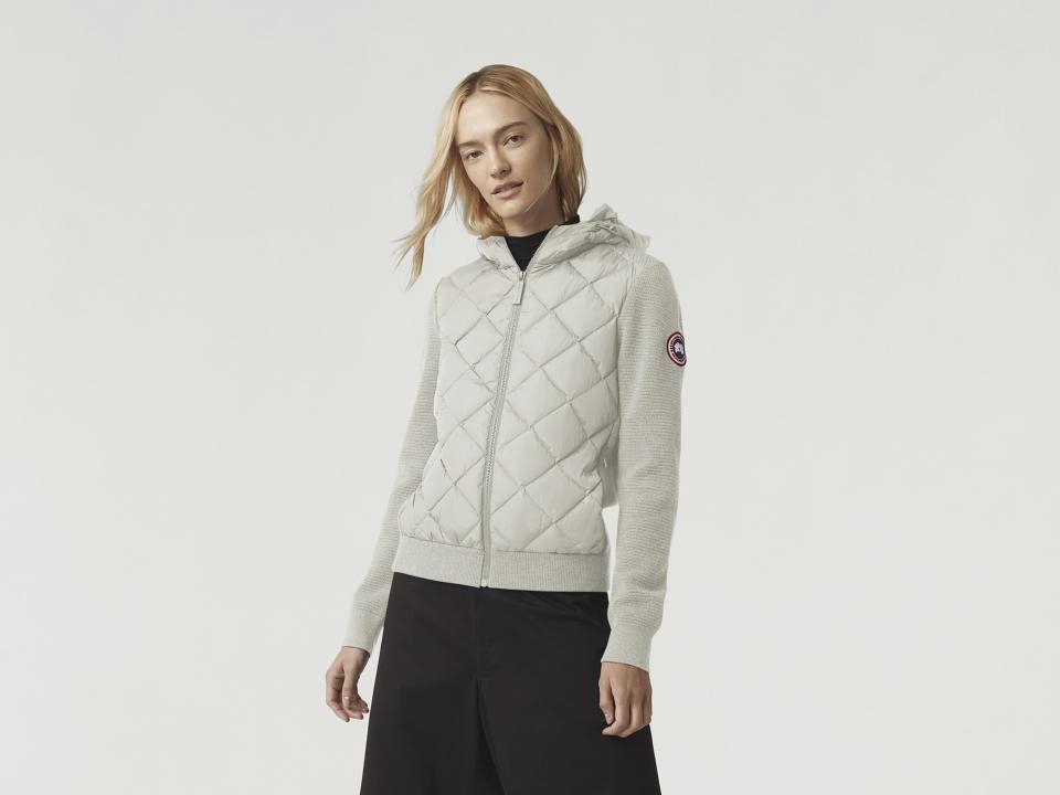 Model wears Canada Goose HyBridge Quilted Knit Hoody in cream