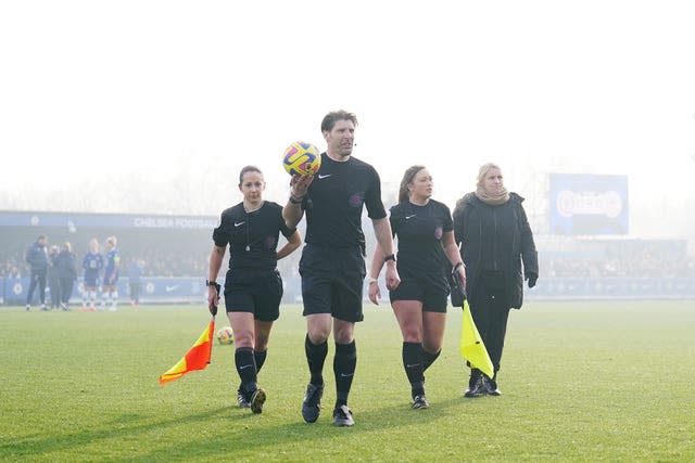 Referee Neil Hair leads the officials off the pitch after abandoning Chelsea's WSL game against Liverpool after just six minutes of play (Zac Goodwin/PA)