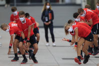 Ball girls and boys exercise before relaying others on second round matches of the French Open tennis tournament at the Roland Garros stadium in Paris, France, Wednesday, Sept. 30, 2020. (AP Photo/Michel Euler)