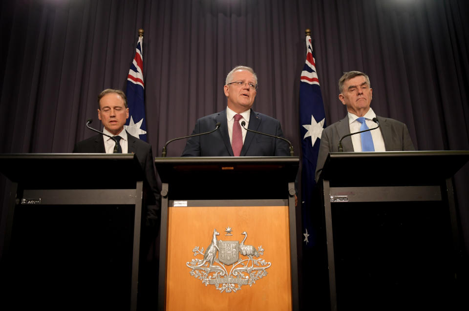 CANBERRA, AUSTRALIA - MARCH 03: Australian Health Minister Greg Hunt (L), Australian Prime Minister Scott Morrison and Australia's Chief Medical Officer Professor Brendan Murphy (R) speak to media in the Blue Room at Parliament House on March 03, 2020 in Canberra, Australia. The Prime Minister Scott Morrison has announced the Federal Government will soon release a strategy outlining plans to help deal with the economic impact of the global coronavirus outbreak. The Reserve Bank is expected to cut interest rates today as the Federal Government works on plans to safeguard the Australian economy amid the current coronavirus outbreak. (Photo by Tracey Nearmy/Getty Images)