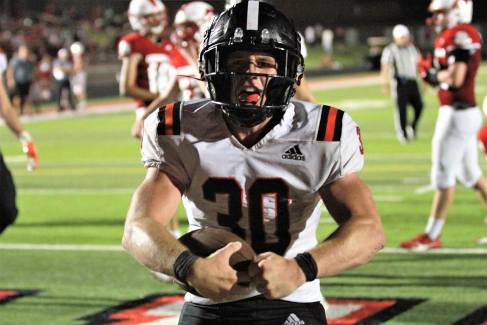 Dalton Tisdel flexes after scoring his third touchdown against Coldwater on Friday night.