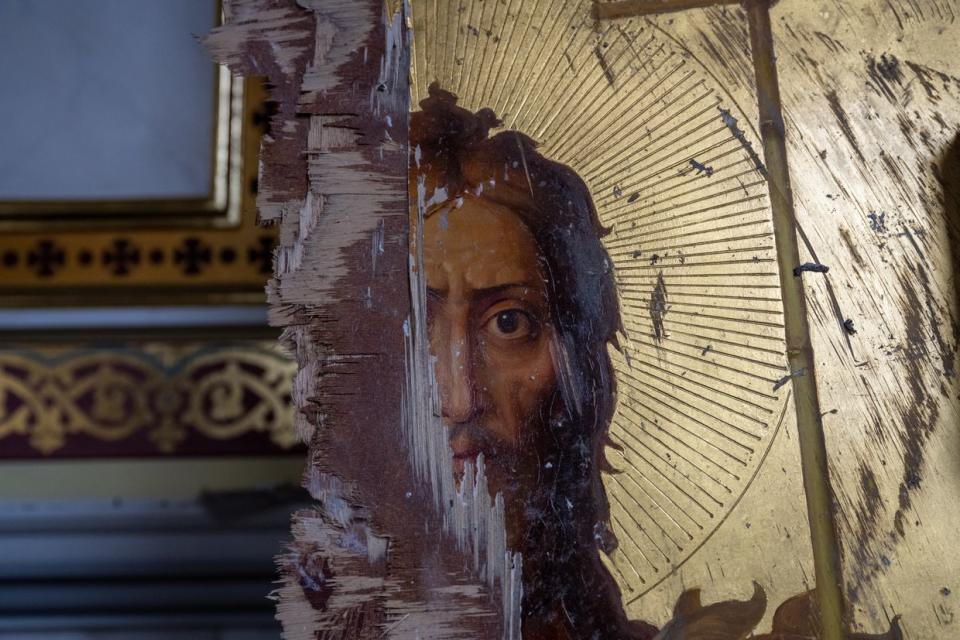 A damaged gilt Orthodox painting of Jesus Christ stands against a wall, as Ukrainians clear away debris after a Russian missile struck the historic Holy Transfiguration Cathedral in central Odesa, Ukraine, on July 23, 2023. (Scott Peterson/Getty Images)