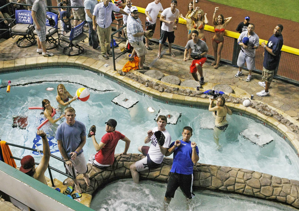 FILE - This July 11, 2011 file photo shows a home-run ball falls into the pool during baseball' All-Star Home Run Derby at Chase Field in Phoenix. All the baseball teams are based in major U.S. cities and many of the stadiums are situated in bustling downtown areas with engrossing things to do and savory places to eat when you aren't attending a game. These attractions should help the cause of baseball fans trying to recruit a spouse or other traveling teammates who may not appreciate the sublime pleasures of the game. (AP Photo/The Arizona Republic, Rob Schumacher) MARICOPA COUNTY OUT NO SALES