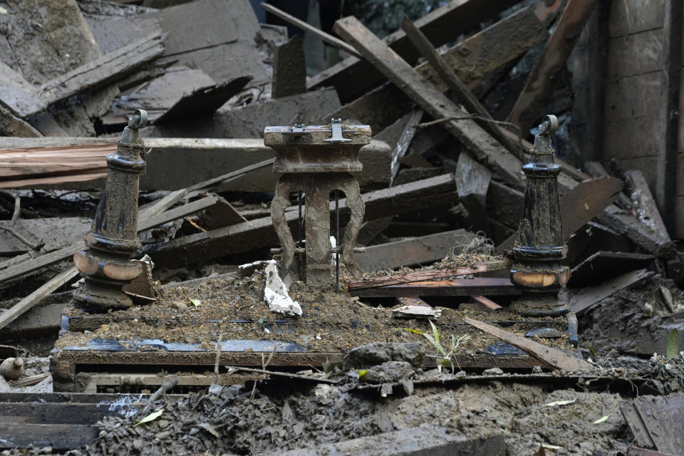 A piano lies in the remains of a destroyed home caused by mud flows during heavy rains in the Beverly Glen section of Beverly Hills, Calif., on Wednesday, Feb. 7, 2024. A storm that parked itself over Southern California for days, unleashing historic downpours that caused hundreds of landslides, was moving out of the region after one final drenching Wednesday, but authorities warned of the continued threat of collapsing hillsides. (AP Photo/Richard Vogel)