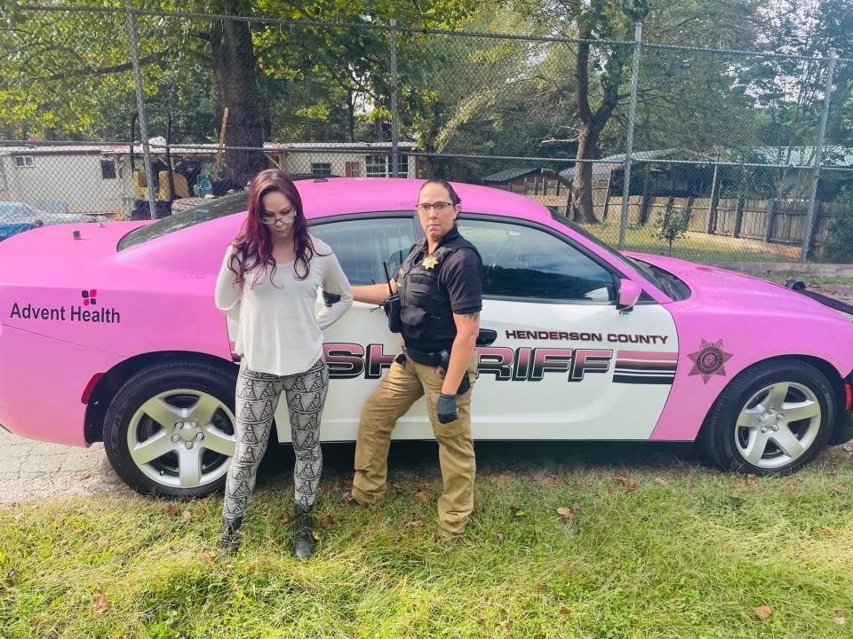 Mackenzie Brown stands handcuffed in front of a Henderson County Sheriff's Office patrol car on Oct. 1, 2021. The social media post is now a part of a federal lawsuit filed by Brown.