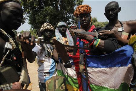 Fighters from the Christian "anti-balaka" militia gesture with their weapons at their headquarters in the northern Bangui suburb of Boeing, an area near the Mpoko International Airport of Bangui February 22, 2014. REUTERS/Luc Gnago