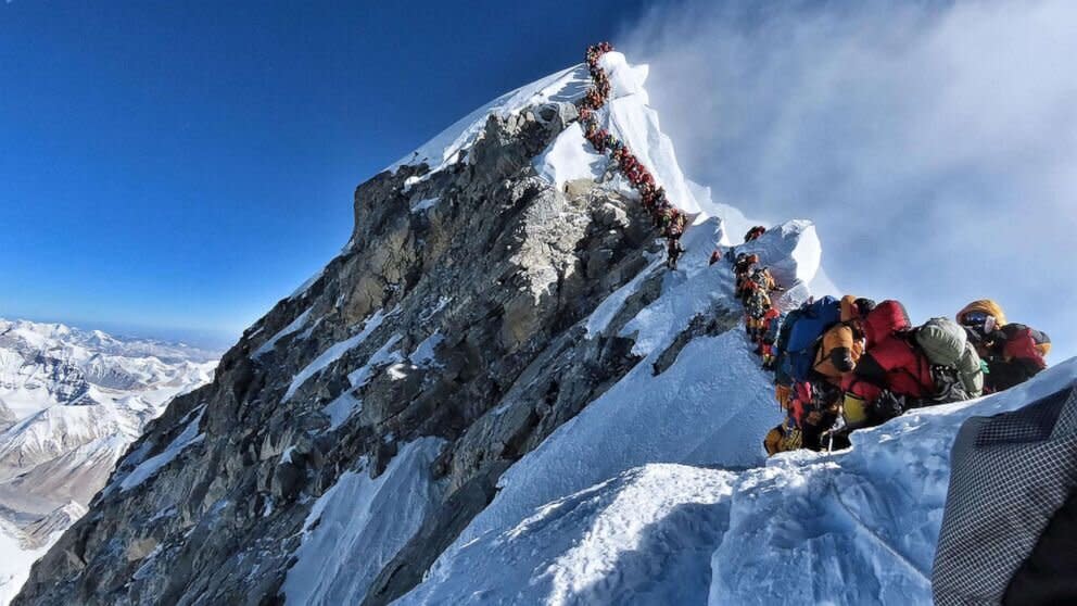 A queue of climbers line the top of Mount Everest. 