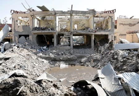 Afghan National Army (ANA) soldiers inspect the site after a blast in Kabul