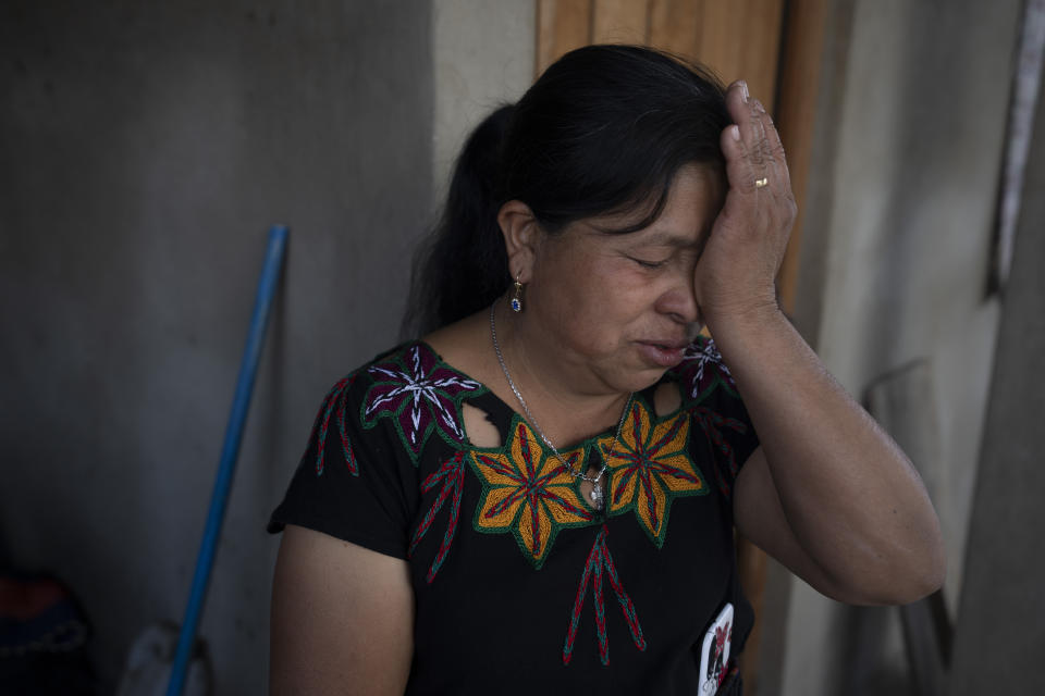 Ana Marina Lopez, wife of Guatemalan migrant Bacilio Sutuj Saravia who died in a fire at a Mexican immigration detention center, cries during an interview at her home in San Martin Jilotepeque, Guatemala, Wednesday, March 29, 2023. According to Mexican President Andres Manuel Lopez Obrador, migrants fearing deportation set mattresses ablaze late Monday at the center, starting a fire that left more than three dozen dead. (AP Photo/Moises Castillo)