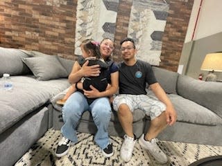 A family checks out furniture at the newly opened Mor Furniture for Less store in the Jess Ranch Marketplace in Apple Valley.