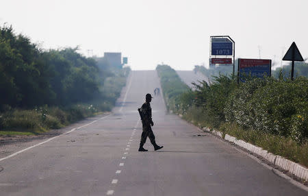 A paramilitary soldier patrols on a closed road leading to Sunariya Jail in Rohtak in Haryana, India, August 27, 2017. REUTERS/Adnan Abidi