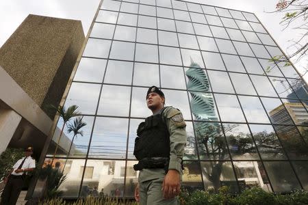 A police officer stands guard outside the Mossack Fonseca law firm office in Panama City April 12, 2016. REUTERS/Carlos Jasso