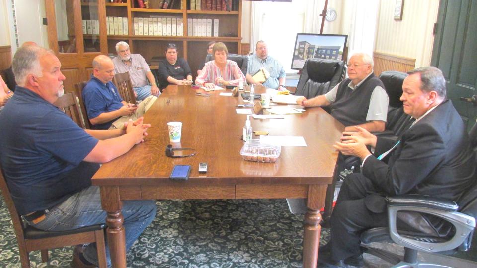 Holmes County Commissioner Dave Hall (front right) addresses a question to State Representative Darrell Kick (front left) and State Senator Andrew Brenner about what Holmes County can do to increase pay for poll workers during elections. Commissioner Joe Miller and members of the Holmes County Board of Election were also on hand for the discussion Monday in the Commissioners' office.