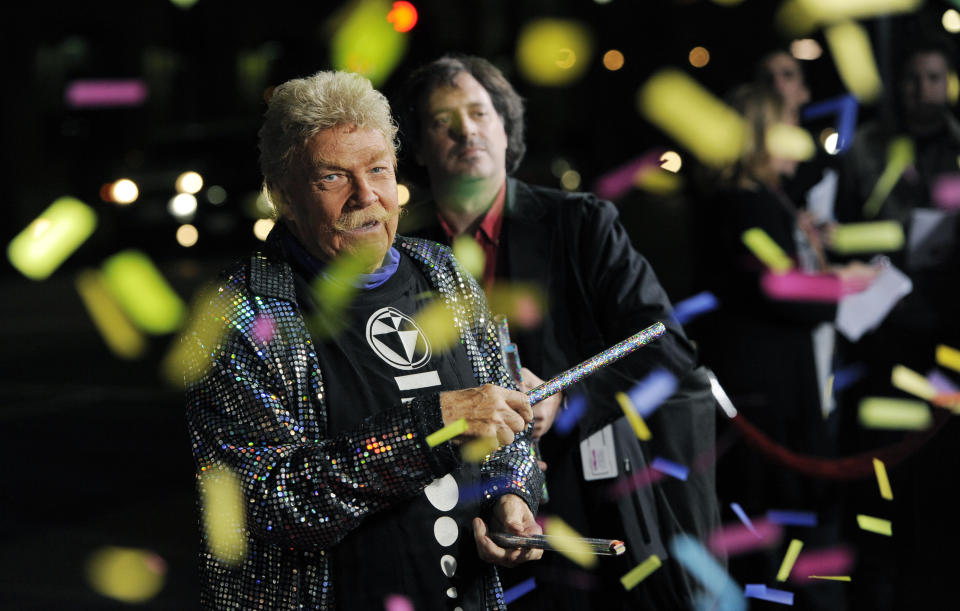 CORRECTS AGE TO 88 - FILE - In this Wednesday, Oct. 13, 2010, file photo, comedian Rip Taylor throws confetti on photographers at the premiere of the film "Jackass 3D," in Los Angeles. Taylor, the mustached comedian with a fondness for confetti-throwing who became a television game show mainstay in the 1970s, died Sunday, Oct. 6, 2019. He was 88. (AP Photo/Chris Pizzello, File)