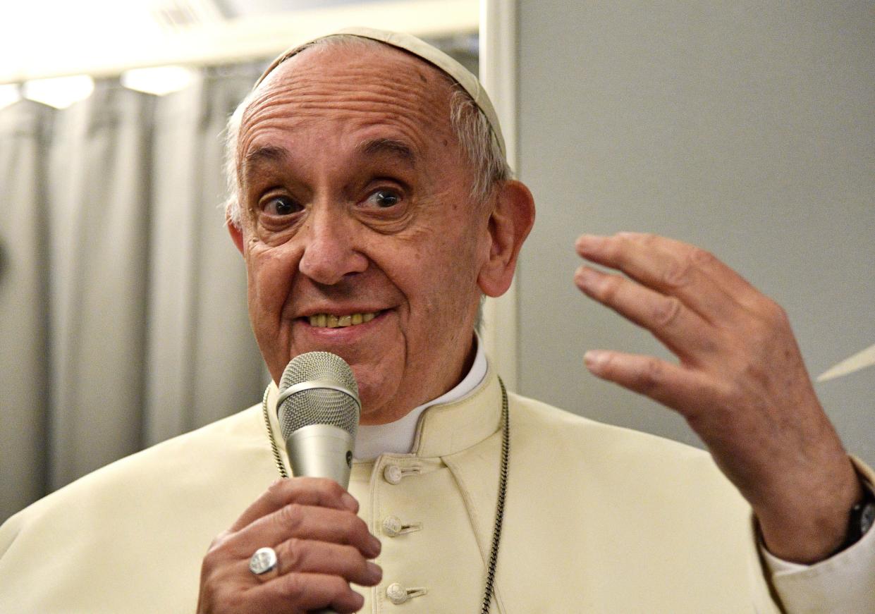 Pope Francis talks during a news conference on board a flight to return to Rome - AFP