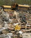 Piles of debris and destroyed buses cover the ground at Page Middle School in Gloucester, Virginia. The worst tornadoes to hit parts of the United States in decades have left 44 people dead, stripping roofs off houses and tossing mobile homes into the air like toys, emergency officials said Sunday