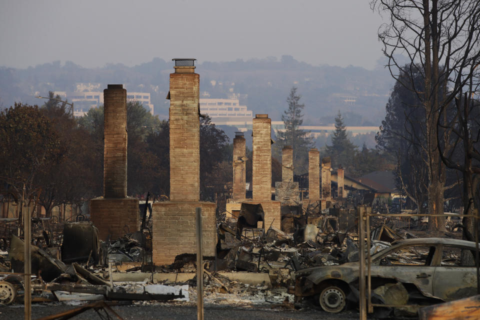 FILE - In this Oct. 13, 2017 file photo, a row of chimneys stand in a neighborhood devastated by a wildfire near Santa Rosa, Calif. Insurance Commissioner Dave Jones is releasing Thursday, Sept. 6, 2018, the first data on the total insurance claims reported for residential and commercial losses following the Carr and Mendocino Complex wildfires. Commissioner Jones will also release updated data for the 2017 California wildfires and 2018 mudslides. (AP Photo/Jae C. Hong, File)