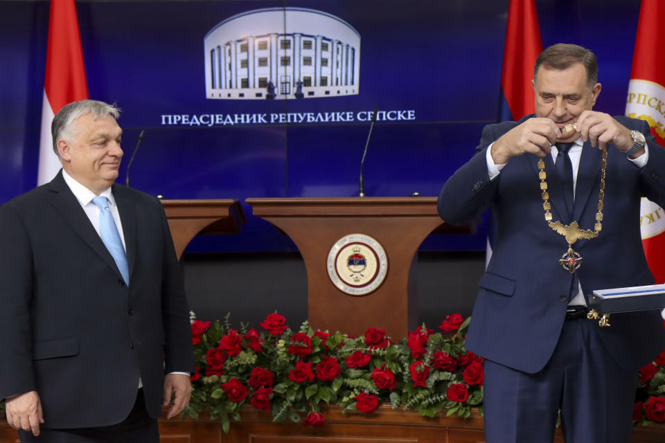 In this photograph made available by the Republika Srpska Presidential Press Service, Hungary's Prime Minister Viktor Orban, left, receives the Order of Republika Srpska from Bosnian Serb leader Milorad Dodik during his visit in Banja Luka, Bosnia, Friday, April 5, 2024. Orban is on a two-day visit to Bosnia and Herzegovina. (Republika Srpska Presidential Press Service via AP)