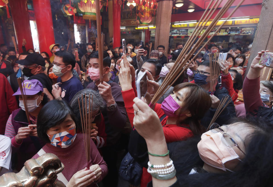 Worshippers wear face masks to help curb the spread of the coronavirus and pray at a temple on the first day of the Lunar New Year celebrations in Taipei, Taiwan, Sunday, Jan. 22, 2023. Each year is named after one of the 12 signs of the Chinese zodiac in a repeating cycle, with this year being the Year of the Rabbit. (AP Photo/Chiang Ying-ying)