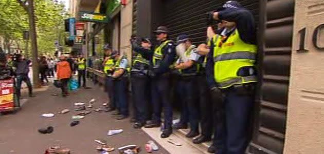 Student protesters hurl shoes at Liberal Party HQ during rally against higher education cuts. Photo: 7News