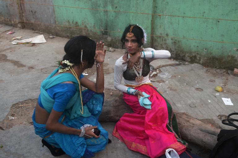 In this photograph taken on April 30, 2013, Indian transgender dancers put on makeup before a performance in Kolkata