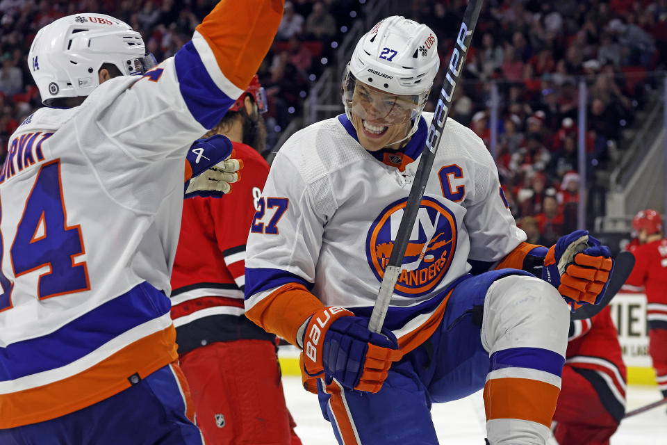 New York Islanders' Anders Lee (27) celebrates after his goal with teammate Bo Horvat (14) during the third period of an NHL hockey game against the Carolina Hurricanes in Raleigh, N.C., Saturday, Dec. 23, 2023. (AP Photo/Karl B DeBlaker)