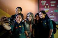 Students take a selfie with Teeraphong Meesat, 29, known as teacher Bally after an English class at the Prasartratprachakit school in Ratchaburi Province