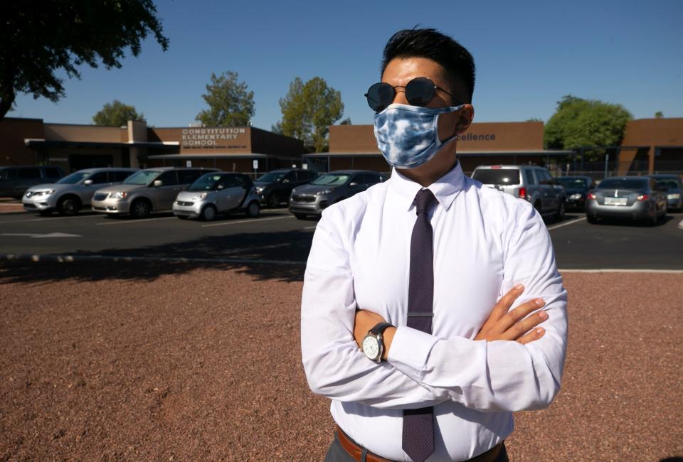 Ruben Miranda, a music and band teacher at Constitution Elementary School, part of the Deer Valley Unified School District, in Phoenix, resigned last week because of COVID-19 concerns just before students returned to the school in person. Miranda who had taught at the school for six years is seen in front of the school on October 1, 2020.  