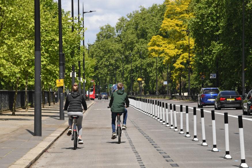 People ride bicycles in a pop-up cycle lane in Park Lane, London: PA
