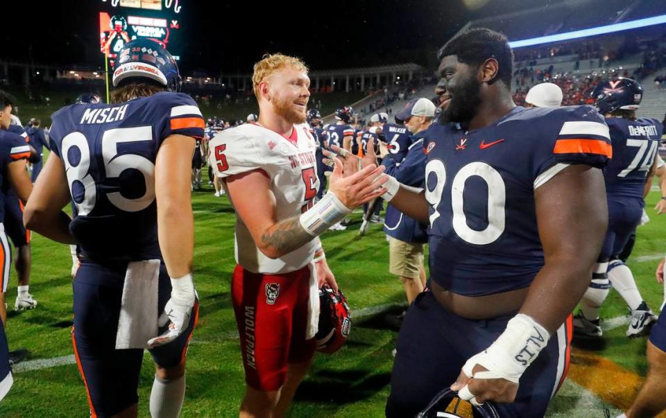 N.C. State quarterback Brennan Armstrong (5) greets Virginia defensive tackle Jahmeer Carter (90) after the Wolfpack’s 24-21 victory over Virginia at Scott Stadium in Charlottesville, Va., Friday, Sept. 22, 2023.